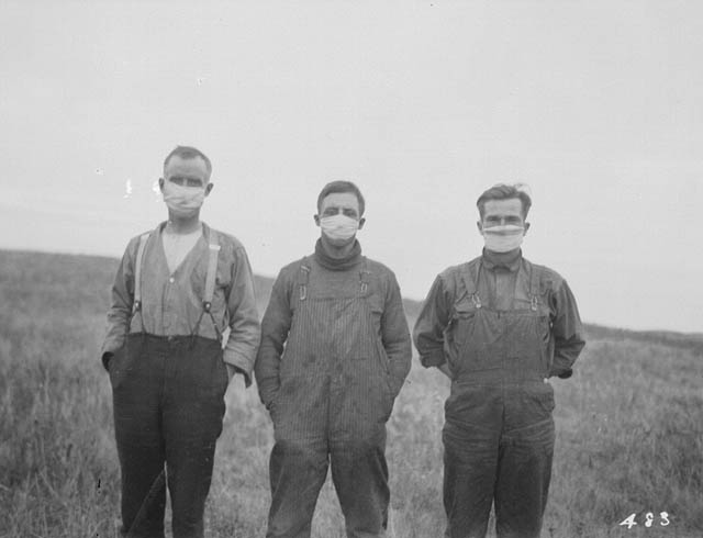 Three men in surgical masks.