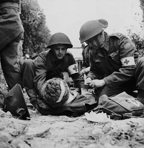 Second World War Chaplains aiding in the evacuation of wounded soldiers